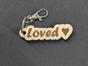 Keychain with the word "Loved" and a heart laser engraved on solid maple